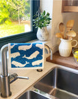 Whales Swedish Dishcloth draped over faucet at a kitchen sink - BESPOKE PROVISIONS